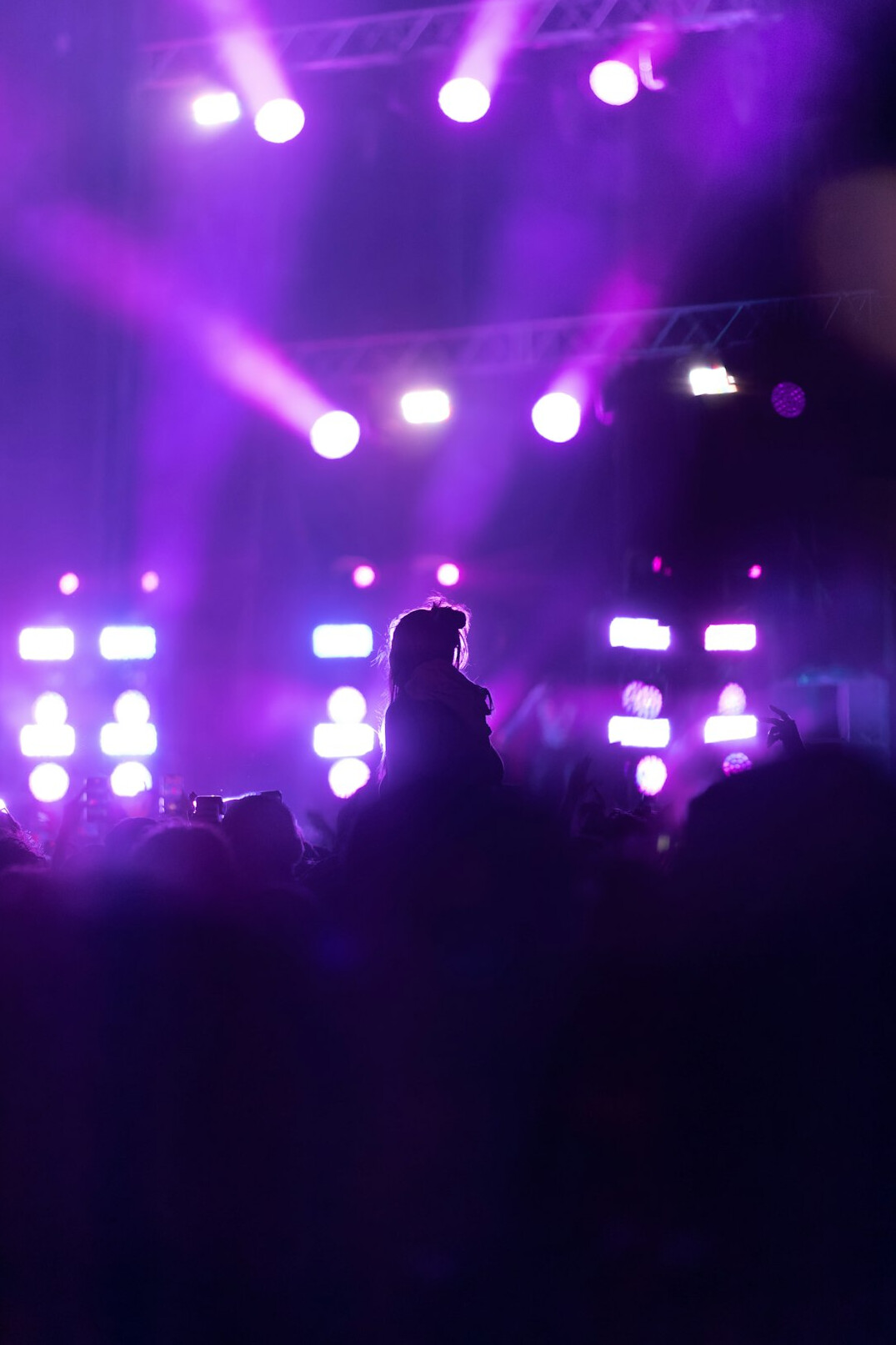 Live concert crowd with bright stage lights